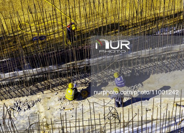 Workers are reinforcing the Yundong Gate at the construction site for the Subei Irrigation Canal in Huai'an, China, on February 16, 2024. 