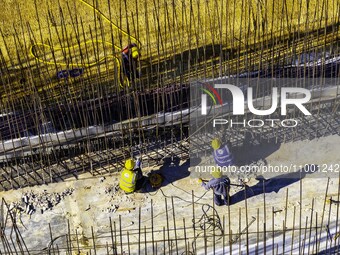 Workers are reinforcing the Yundong Gate at the construction site for the Subei Irrigation Canal in Huai'an, China, on February 16, 2024. (