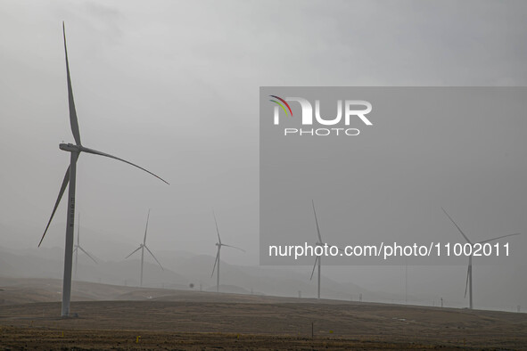 Wind turbines are standing under a sandstorm in Yongchang, Gansu Province, China, on February 17, 2024. 