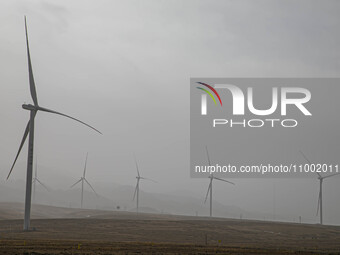 Wind turbines are standing under a sandstorm in Yongchang, Gansu Province, China, on February 17, 2024. (