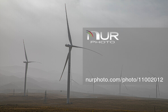 Wind turbines are standing under a sandstorm in Yongchang, Gansu Province, China, on February 17, 2024. 