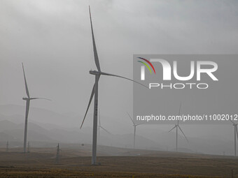 Wind turbines are standing under a sandstorm in Yongchang, Gansu Province, China, on February 17, 2024. (