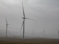 Wind turbines are standing under a sandstorm in Yongchang, Gansu Province, China, on February 17, 2024. (