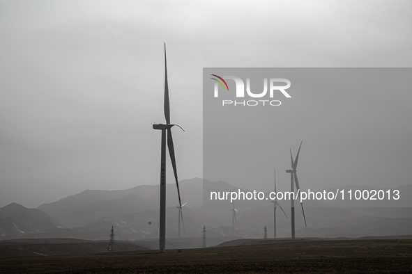 Wind turbines are standing under a sandstorm in Yongchang, Gansu Province, China, on February 17, 2024. 