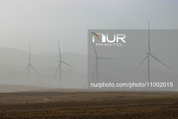 Wind turbines are standing under a sandstorm in Yongchang, Gansu Province, China, on February 17, 2024. 