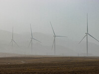 Wind turbines are standing under a sandstorm in Yongchang, Gansu Province, China, on February 17, 2024. (