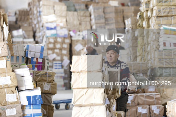 Staff members are distributing new teaching materials at the storage and transportation center of Xinhua Bookstore in Suqian, Jiangsu provin...