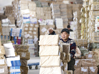 Staff members are distributing new teaching materials at the storage and transportation center of Xinhua Bookstore in Suqian, Jiangsu provin...