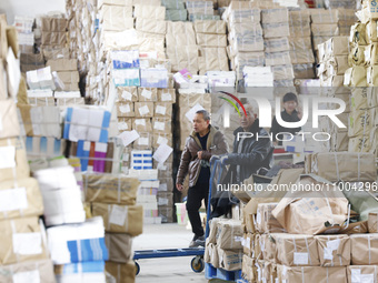 Staff members are distributing new teaching materials at the storage and transportation center of Xinhua Bookstore in Suqian, Jiangsu provin...