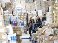 Staff members are distributing new teaching materials at the storage and transportation center of Xinhua Bookstore in Suqian, Jiangsu provin...