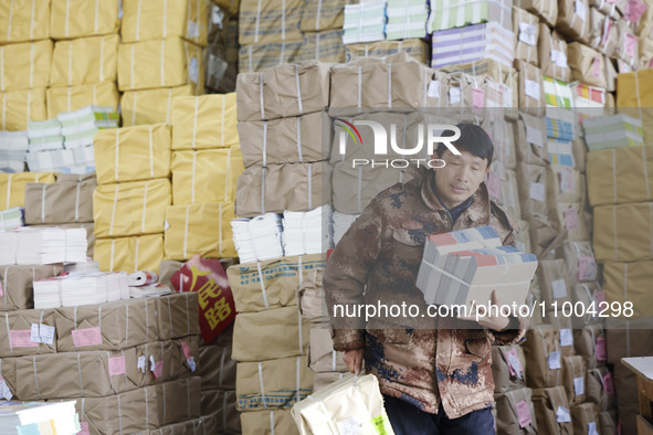 Staff members are distributing new teaching materials at the storage and transportation center of Xinhua Bookstore in Suqian, Jiangsu provin...