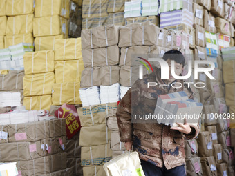 Staff members are distributing new teaching materials at the storage and transportation center of Xinhua Bookstore in Suqian, Jiangsu provin...