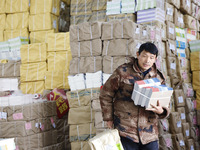 Staff members are distributing new teaching materials at the storage and transportation center of Xinhua Bookstore in Suqian, Jiangsu provin...