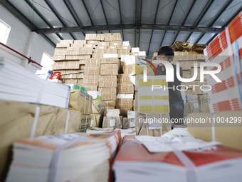 Staff members are distributing new teaching materials at the storage and transportation center of Xinhua Bookstore in Suqian, Jiangsu provin...