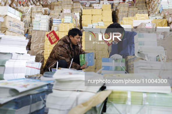 Staff members are distributing new teaching materials at the storage and transportation center of Xinhua Bookstore in Suqian, Jiangsu provin...