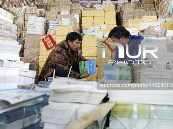 Staff members are distributing new teaching materials at the storage and transportation center of Xinhua Bookstore in Suqian, Jiangsu provin...