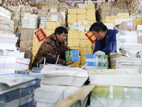 Staff members are distributing new teaching materials at the storage and transportation center of Xinhua Bookstore in Suqian, Jiangsu provin...