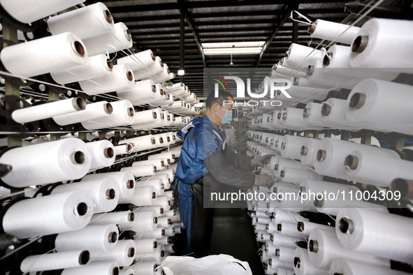 A worker is producing textile products at a workshop of a production enterprise in the Lianyun district, Lianyungang City, China, on Februar...