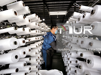 A worker is producing textile products at a workshop of a production enterprise in the Lianyun district, Lianyungang City, China, on Februar...