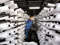 A worker is producing textile products at a workshop of a production enterprise in the Lianyun district, Lianyungang City, China, on Februar...