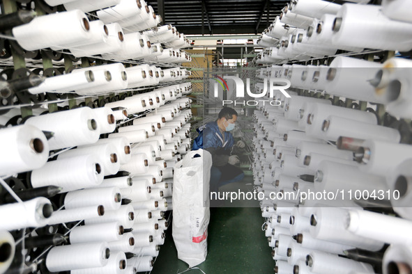 A worker is producing textile products at a workshop of a production enterprise in the Lianyun district, Lianyungang City, China, on Februar...