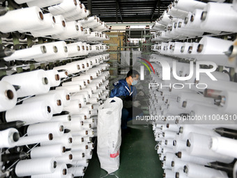 A worker is producing textile products at a workshop of a production enterprise in the Lianyun district, Lianyungang City, China, on Februar...