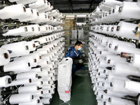 A worker is producing textile products at a workshop of a production enterprise in the Lianyun district, Lianyungang City, China, on Februar...