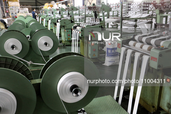 A worker is producing textile products at a workshop of a production enterprise in the Lianyun district, Lianyungang City, China, on Februar...