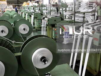 A worker is producing textile products at a workshop of a production enterprise in the Lianyun district, Lianyungang City, China, on Februar...