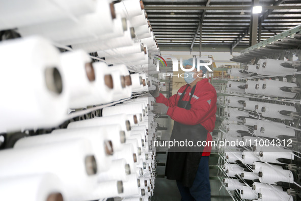 A worker is producing textile products at a workshop of a production enterprise in the Lianyun district, Lianyungang City, China, on Februar...