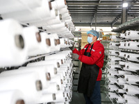 A worker is producing textile products at a workshop of a production enterprise in the Lianyun district, Lianyungang City, China, on Februar...