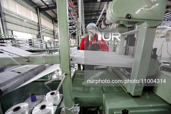 A worker is producing textile products at a workshop of a production enterprise in the Lianyun district, Lianyungang City, China, on Februar...