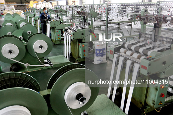 A worker is producing textile products at a workshop of a production enterprise in the Lianyun district, Lianyungang City, China, on Februar...