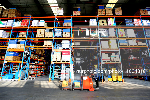 Workers are working at a warehouse at a logistics enterprise in the Lianyun district of Lianyungang city, Jiangsu province, East China, on F...