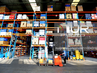 Workers are working at a warehouse at a logistics enterprise in the Lianyun district of Lianyungang city, Jiangsu province, East China, on F...