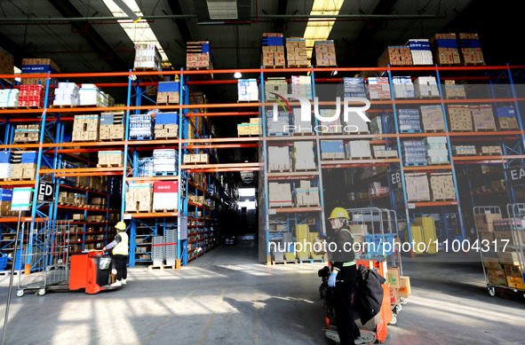 Workers are working at a warehouse at a logistics enterprise in the Lianyun district of Lianyungang city, Jiangsu province, East China, on F...