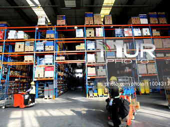 Workers are working at a warehouse at a logistics enterprise in the Lianyun district of Lianyungang city, Jiangsu province, East China, on F...