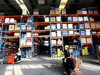 Workers are working at a warehouse at a logistics enterprise in the Lianyun district of Lianyungang city, Jiangsu province, East China, on F...