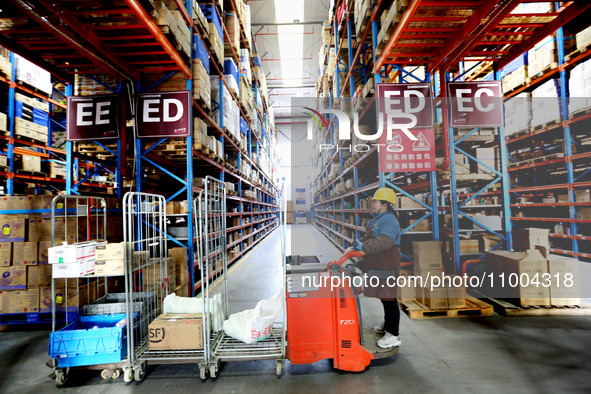 Workers are working at a warehouse at a logistics enterprise in the Lianyun district of Lianyungang city, Jiangsu province, East China, on F...