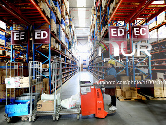 Workers are working at a warehouse at a logistics enterprise in the Lianyun district of Lianyungang city, Jiangsu province, East China, on F...