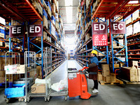 Workers are working at a warehouse at a logistics enterprise in the Lianyun district of Lianyungang city, Jiangsu province, East China, on F...