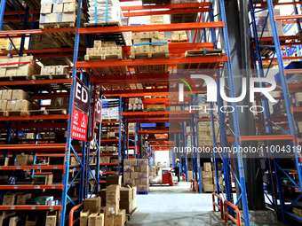 Workers are working at a warehouse at a logistics enterprise in the Lianyun district of Lianyungang city, Jiangsu province, East China, on F...