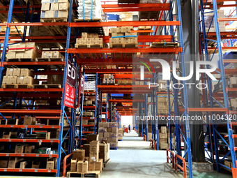 Workers are working at a warehouse at a logistics enterprise in the Lianyun district of Lianyungang city, Jiangsu province, East China, on F...