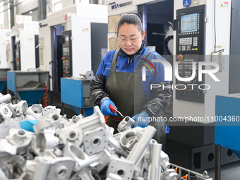 A worker is producing auto parts at a company in Lianyungang, China, on February 18, 2024. (