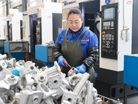 A worker is producing auto parts at a company in Lianyungang, China, on February 18, 2024. (