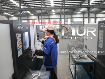 A worker is producing auto parts at a company in Lianyungang, China, on February 18, 2024. (