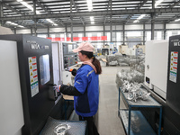 A worker is producing auto parts at a company in Lianyungang, China, on February 18, 2024. (