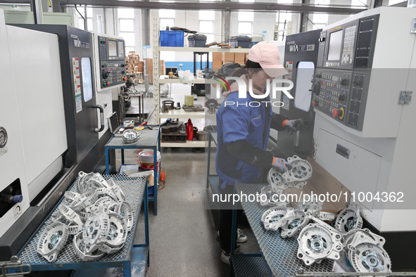 A worker is producing auto parts at a company in Lianyungang, China, on February 18, 2024. 