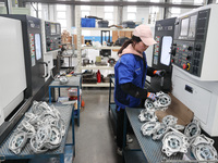 A worker is producing auto parts at a company in Lianyungang, China, on February 18, 2024. (