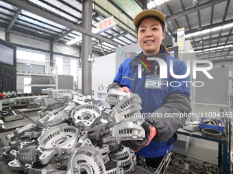 A worker is producing auto parts at a company in Lianyungang, China, on February 18, 2024. (